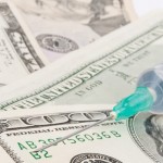 Syringe on the Dollar-bills – financial injection concept